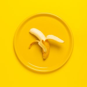 Fresh banana on yellow plate